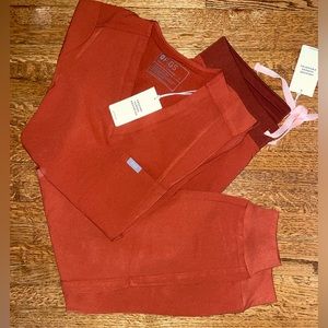 Women’s Auburn color FIGS scrub set, one pocket scrub top and jogger pants.